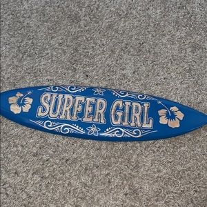 blue tiny surf board with surfer girl on it
